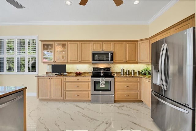 5018 Bella Terra Dr, Venice, FL 34293 - kitchen with appliances with stainless steel finishes, a ceiling fan, crown molding, dark stone countertops, and backsplash