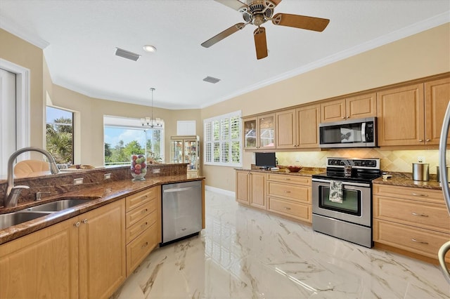 5018 Bella Terra Dr, Venice, FL 34293 - kitchen featuring stainless steel appliances, tasteful backsplash, ornamental molding, light marble finish flooring, and dark stone countertops
