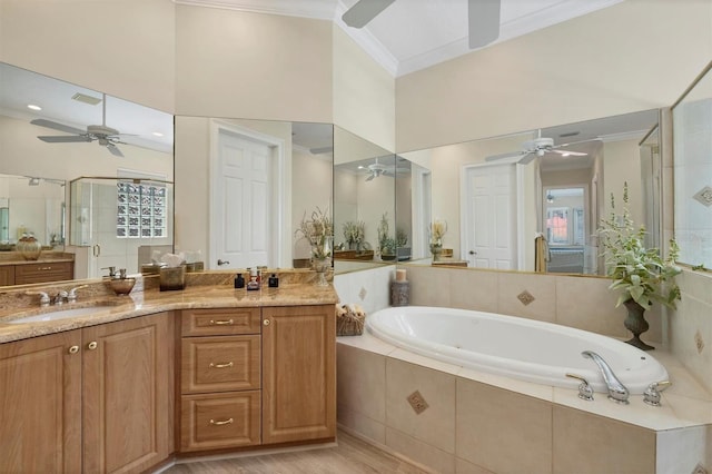 5018 Bella Terra Dr, Venice, FL 34293 - bathroom with ceiling fan, crown molding, a garden tub, a shower stall, and vanity