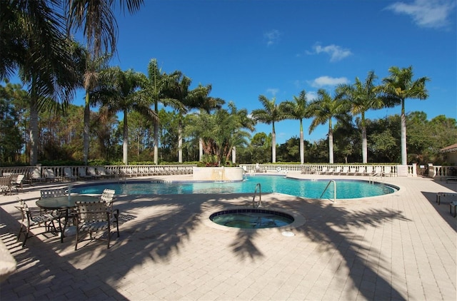 5018 Bella Terra Dr, Venice, FL 34293 - community pool featuring a hot tub, view of scattered trees, and a patio