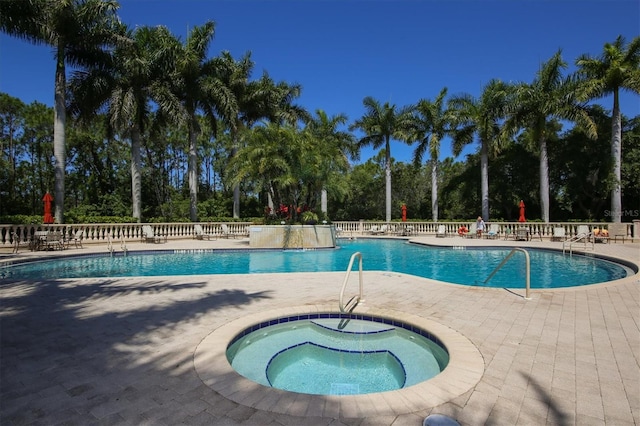 5018 Bella Terra Dr, Venice, FL 34293 - community pool featuring a hot tub, a patio area, and view of scattered trees