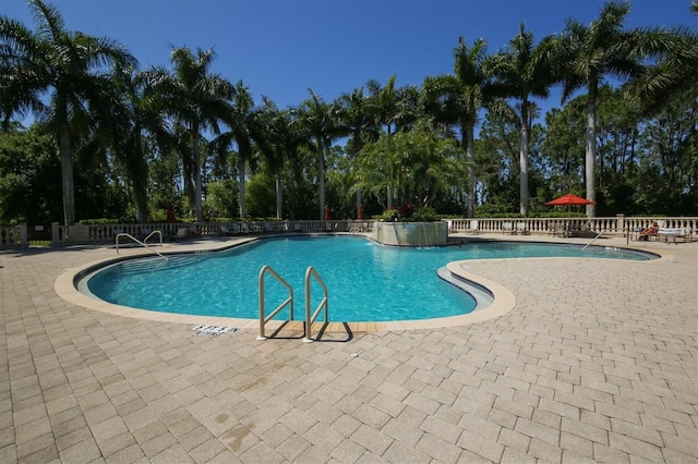 5018 Bella Terra Dr, Venice, FL 34293 - community pool featuring a patio area and view of scattered trees