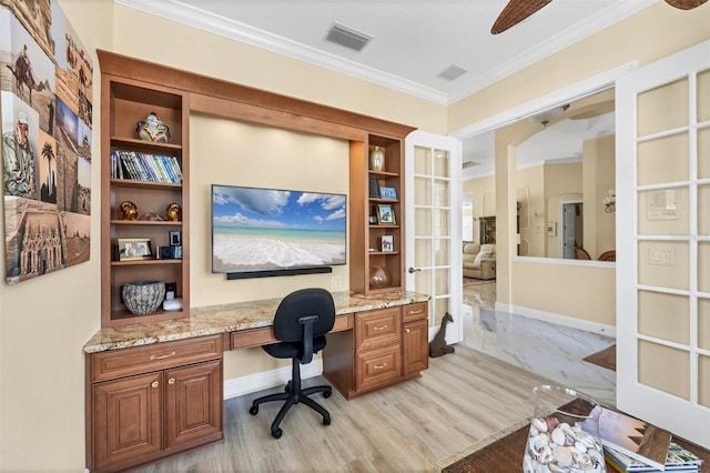 5018 Bella Terra Dr, Venice, FL 34293 - home office featuring built in desk, ornamental molding, light wood-style floors, built in features, and ceiling fan