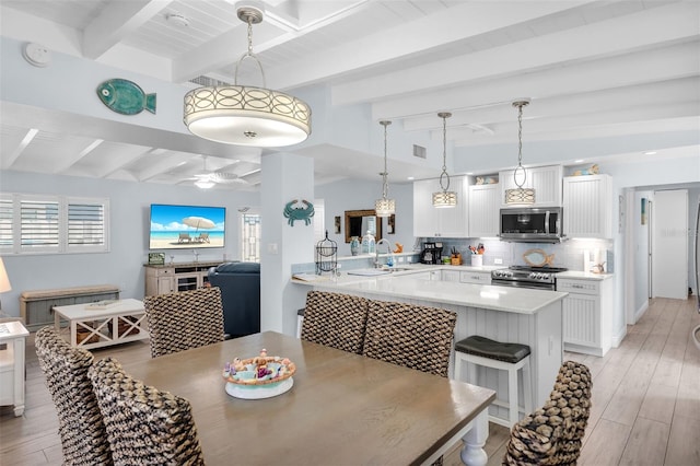 8 Sadowski Cswy, Key Colony Beach, FL 33051 - dining space featuring beam ceiling, light wood-style flooring, and a ceiling fan