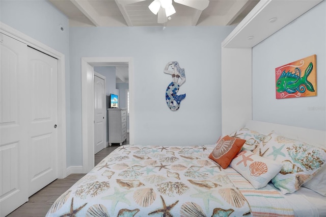 8 Sadowski Cswy, Key Colony Beach, FL 33051 - bedroom featuring wood finished floors, a closet, beam ceiling, and ceiling fan