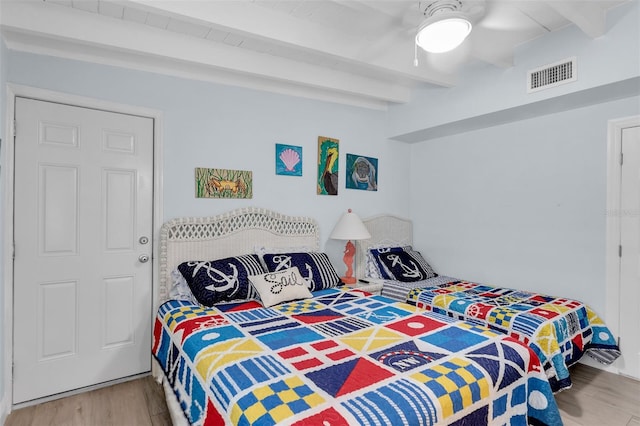 8 Sadowski Cswy, Key Colony Beach, FL 33051 - bedroom featuring wood finished floors, beam ceiling, and a ceiling fan