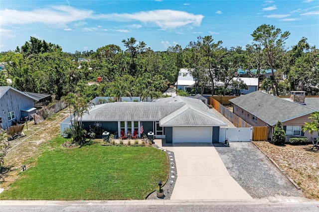 5207 5th Avenue Dr NW, Bradenton, FL 34209 - view of front of property with an attached garage, concrete driveway, a gate, and roof with shingles