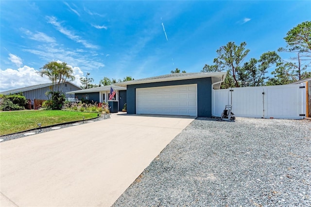 5207 5th Avenue Dr NW, Bradenton, FL 34209 - view of front facade featuring a gate, concrete driveway, an attached garage, and stucco siding