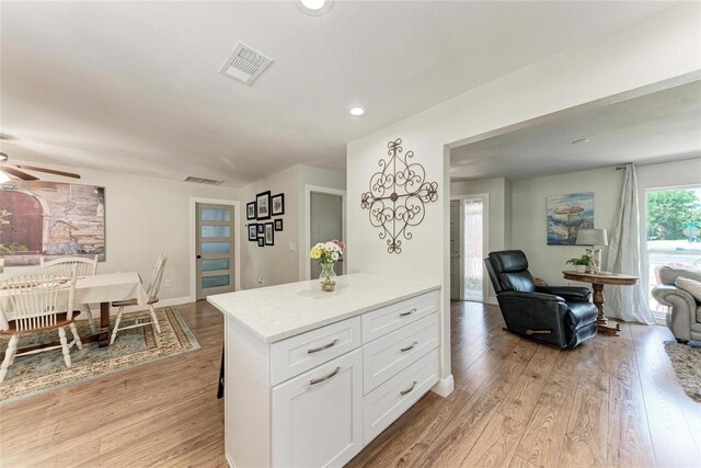 5207 5th Avenue Dr NW, Bradenton, FL 34209 - kitchen featuring light countertops, white cabinets, light wood-style floors, a ceiling fan, and recessed lighting