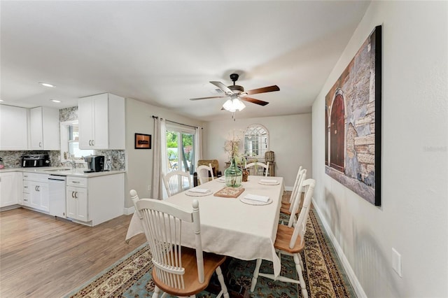 5207 5th Avenue Dr NW, Bradenton, FL 34209 - dining space with light wood-style flooring, a ceiling fan, and baseboards