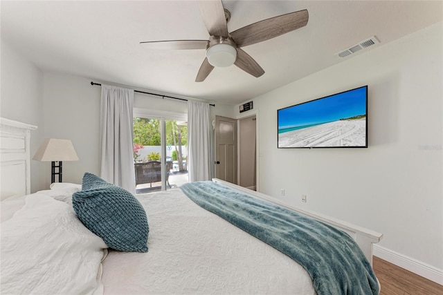 5207 5th Avenue Dr NW, Bradenton, FL 34209 - bedroom with access to exterior, wood finished floors, baseboards, and ceiling fan