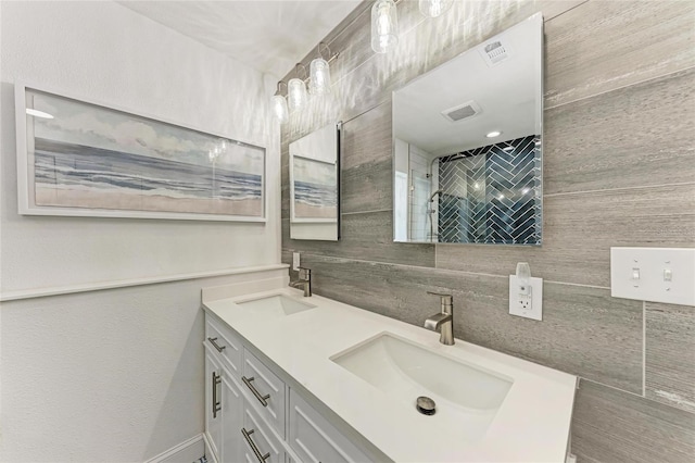 5207 5th Avenue Dr NW, Bradenton, FL 34209 - bathroom featuring double vanity, tile walls, backsplash, and a tile shower