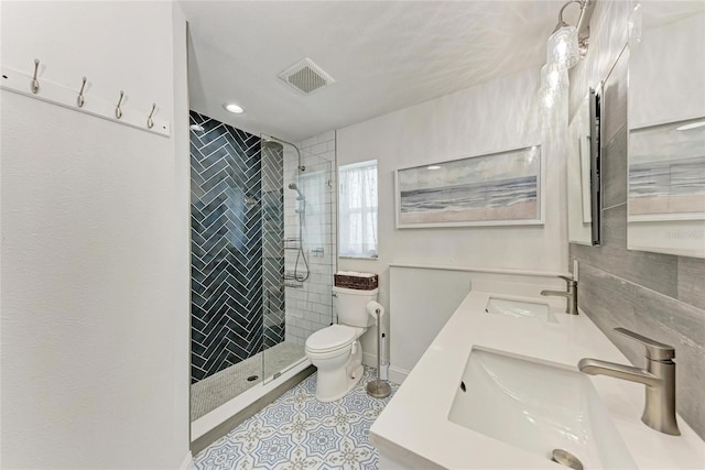 5207 5th Avenue Dr NW, Bradenton, FL 34209 - bathroom featuring toilet, a shower stall, double vanity, and tile patterned flooring