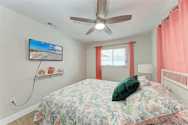 5207 5th Avenue Dr NW, Bradenton, FL 34209 - bedroom with baseboards, wood finished floors, and a ceiling fan