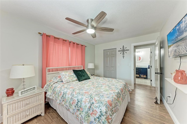 5207 5th Avenue Dr NW, Bradenton, FL 34209 - bedroom featuring wood finished floors, a ceiling fan, baseboards, a closet, and a textured ceiling