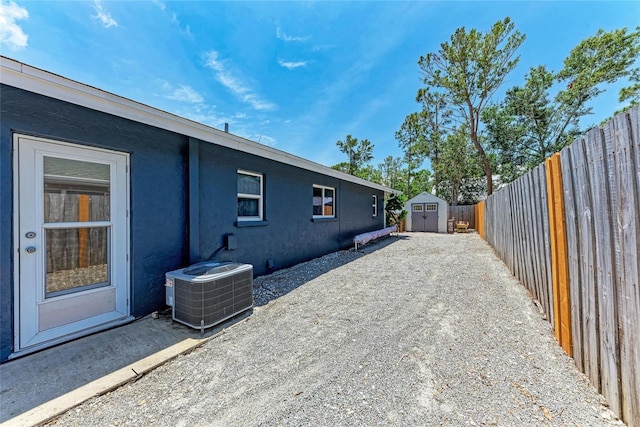5207 5th Avenue Dr NW, Bradenton, FL 34209 - view of home's exterior with central air condition unit, a fenced backyard, and stucco siding
