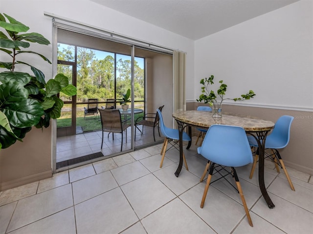 25050 Sandhill Blvd Unit 6A3, Punta Gorda, FL 33983 - dining room featuring baseboards and light tile patterned floors