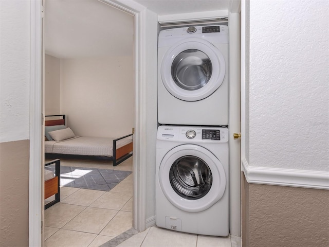 25050 Sandhill Blvd Unit 6A3, Punta Gorda, FL 33983 - laundry room with stacked washer / drying machine, a textured wall, and light tile patterned floors