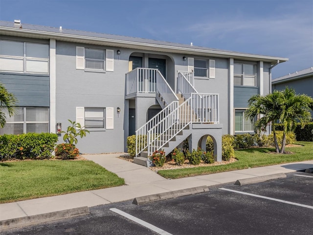 25050 Sandhill Blvd Unit 6A3, Punta Gorda, FL 33983 - view of building exterior featuring uncovered parking and stairway