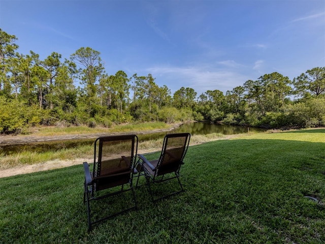 25050 Sandhill Blvd Unit 6A3, Punta Gorda, FL 33983 - view of green lawn featuring a water view