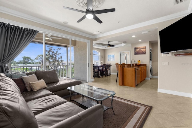 235 Base Ave E Unit 207, Venice, FL 34285 - living room with a ceiling fan, stacked washing machine and dryer, crown molding, light tile patterned floors, and recessed lighting