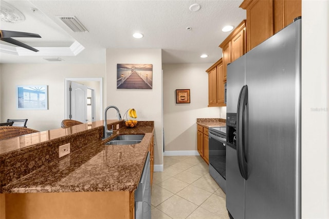 235 Base Ave E Unit 207, Venice, FL 34285 - kitchen with appliances with stainless steel finishes, ceiling fan, a peninsula, brown cabinets, and recessed lighting