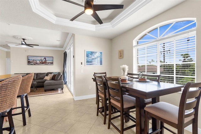 235 Base Ave E Unit 207, Venice, FL 34285 - dining room featuring ceiling fan, crown molding, light tile patterned floors, and a tray ceiling