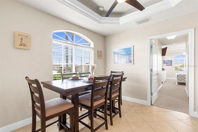235 Base Ave E Unit 207, Venice, FL 34285 - dining area featuring a raised ceiling, a ceiling fan, light tile patterned floors, and ornamental molding