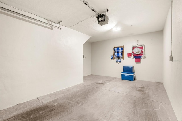235 Base Ave E Unit 207, Venice, FL 34285 - garage featuring a garage door opener