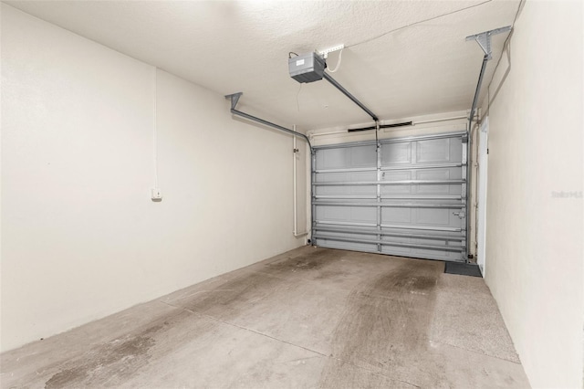 235 Base Ave E Unit 207, Venice, FL 34285 - garage featuring a garage door opener
