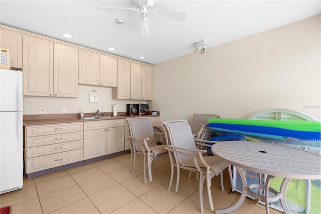 235 Base Ave E Unit 207, Venice, FL 34285 - kitchen with freestanding refrigerator, light tile patterned floors, light brown cabinets, ceiling fan, and recessed lighting