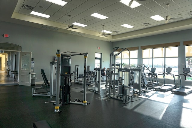 136 Positano Trl, Nokomis, FL 34275 - gym featuring a paneled ceiling, ceiling fan, a raised ceiling, and a high ceiling