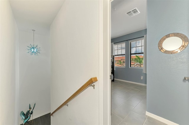 10213 Staggerbush Dr Unit 202, Venice, FL 34293 - hallway with an upstairs landing, baseboards, and tile patterned flooring