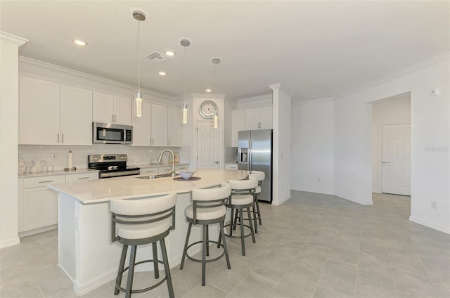 10213 Staggerbush Dr Unit 202, Venice, FL 34293 - kitchen with appliances with stainless steel finishes, a sink, decorative backsplash, an island with sink, and white cabinetry