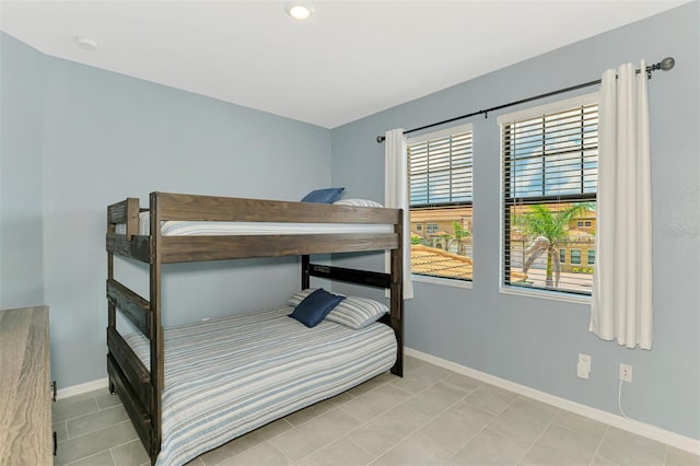 10213 Staggerbush Dr Unit 202, Venice, FL 34293 - bedroom featuring baseboards and light tile patterned floors