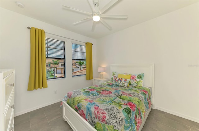 10213 Staggerbush Dr Unit 202, Venice, FL 34293 - bedroom with tile patterned flooring, baseboards, and a ceiling fan