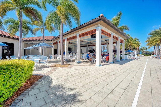 10213 Staggerbush Dr Unit 202, Venice, FL 34293 - rear view of property with ceiling fan, outdoor dining space, a patio area, and a tile roof