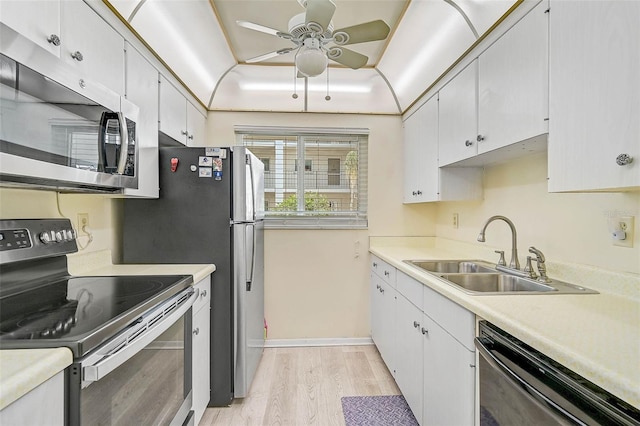 708 Tamiami Trl S Unit 115, Venice, FL 34285 - kitchen featuring appliances with stainless steel finishes, light wood-type flooring, ceiling fan, light countertops, and white cabinets
