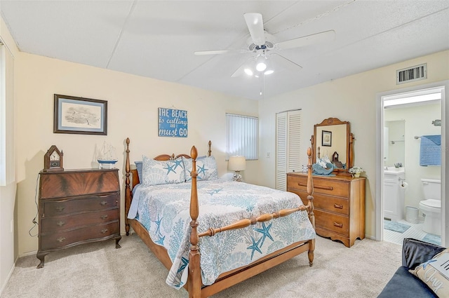 708 Tamiami Trl S Unit 115, Venice, FL 34285 - bedroom with light carpet, a closet, connected bathroom, and ceiling fan