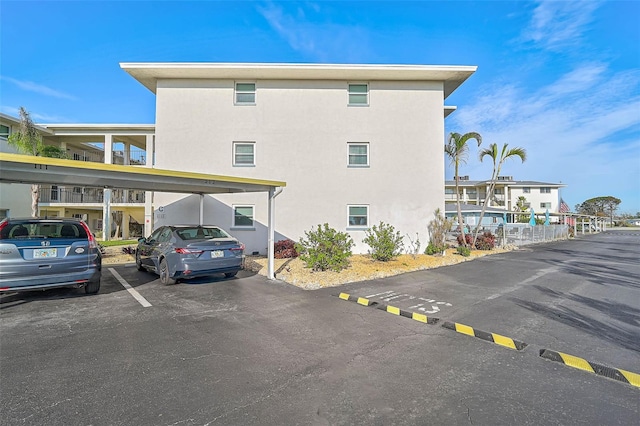 708 Tamiami Trl S Unit 115, Venice, FL 34285 - view of property exterior with covered parking and stucco siding