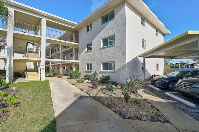 708 Tamiami Trl S Unit 115, Venice, FL 34285 - view of apartment building / complex featuring covered parking