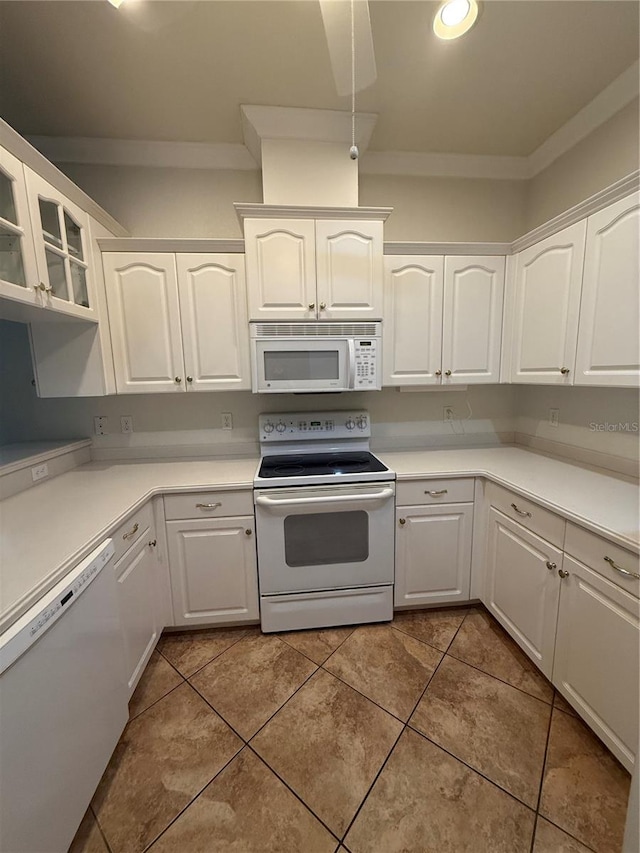 3790 Cadbury Cir Unit 40, Venice, FL 34293 - kitchen featuring white appliances, white cabinetry, and crown molding