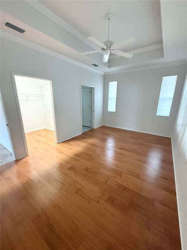3790 Cadbury Cir Unit 40, Venice, FL 34293 - unfurnished room with crown molding, a raised ceiling, light wood-style flooring, a ceiling fan, and baseboards