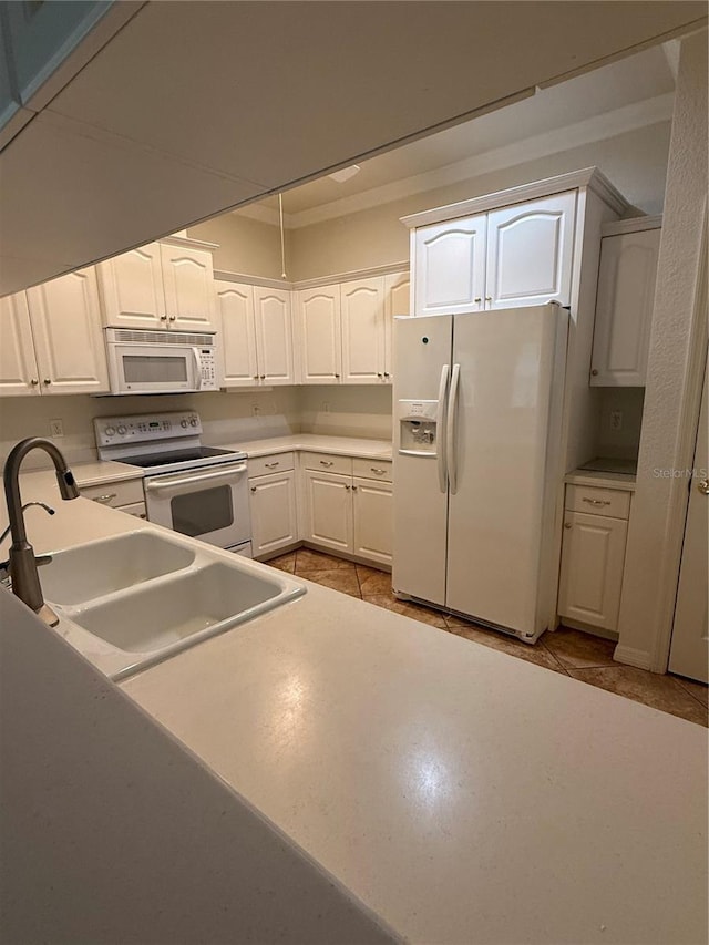 3790 Cadbury Cir Unit 40, Venice, FL 34293 - kitchen featuring white appliances, a sink, white cabinets, light countertops, and light tile patterned flooring