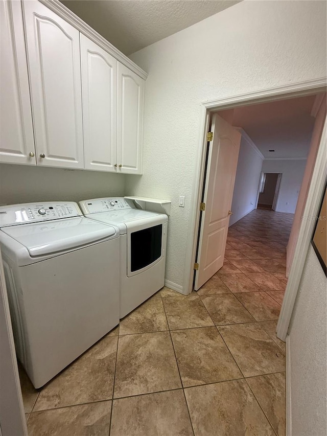 3790 Cadbury Cir Unit 40, Venice, FL 34293 - washroom with independent washer and dryer, cabinet space, light tile patterned flooring, and a textured wall