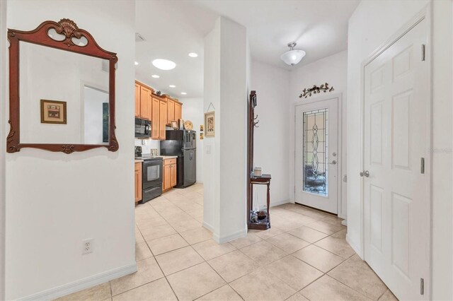 11103 Batello Dr, Venice, FL 34292 - foyer with light tile patterned floors and recessed lighting