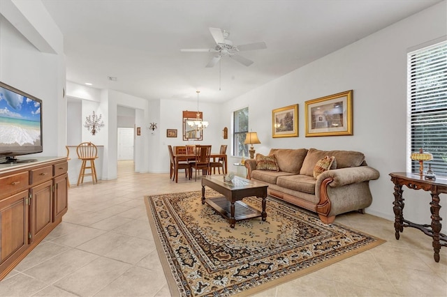 11103 Batello Dr, Venice, FL 34292 - living room with light tile patterned flooring, a ceiling fan, and plenty of natural light