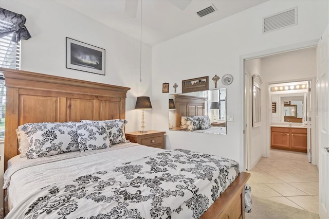 11103 Batello Dr, Venice, FL 34292 - bedroom featuring light tile patterned floors, multiple windows, and ensuite bathroom