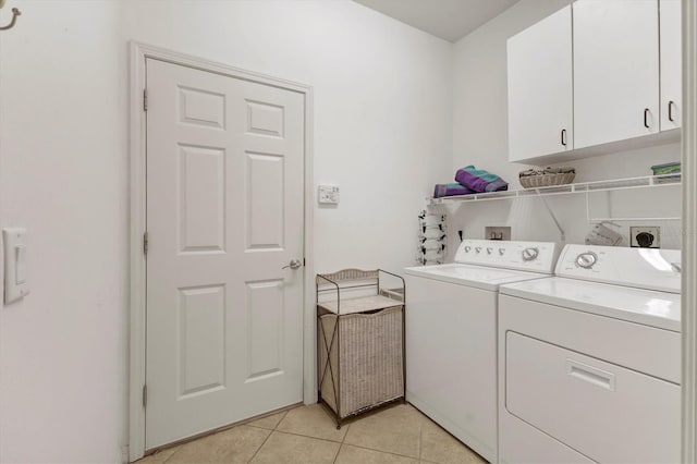 11103 Batello Dr, Venice, FL 34292 - washroom with washer and dryer, cabinet space, and light tile patterned flooring