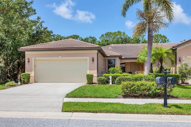 11103 Batello Dr, Venice, FL 34292 - mediterranean / spanish-style home with a tiled roof, a garage, concrete driveway, and stucco siding